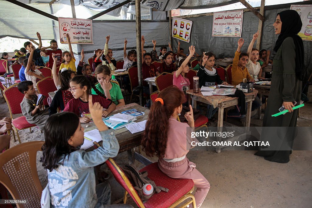 TOPSHOT - Children attend a class in a tent being used as a make-shift educational centre for primary education students in Jabalia in the northern Gaza Strip on September 8, 2024 amid the ongoing war in the Palestinian territory between Israel and Hamas. (Photo by Omar AL-QATTAA / AFP) (Photo by OMAR AL-QATTAA/AFP via Getty Images)